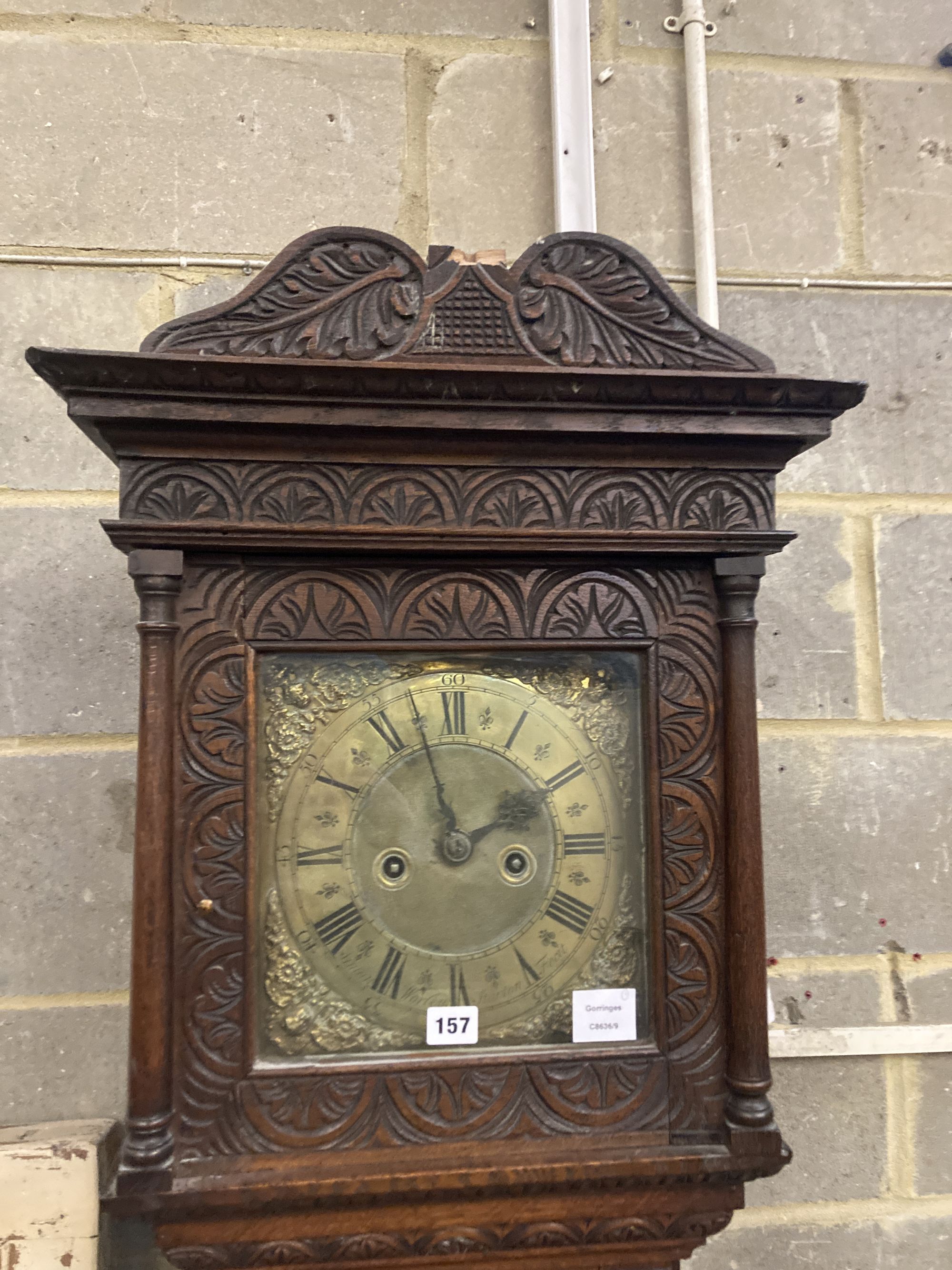 Simon Worley of Starton - an early 18th century 8 day longcase clock, contained in a later carved oak vase, height 210cm